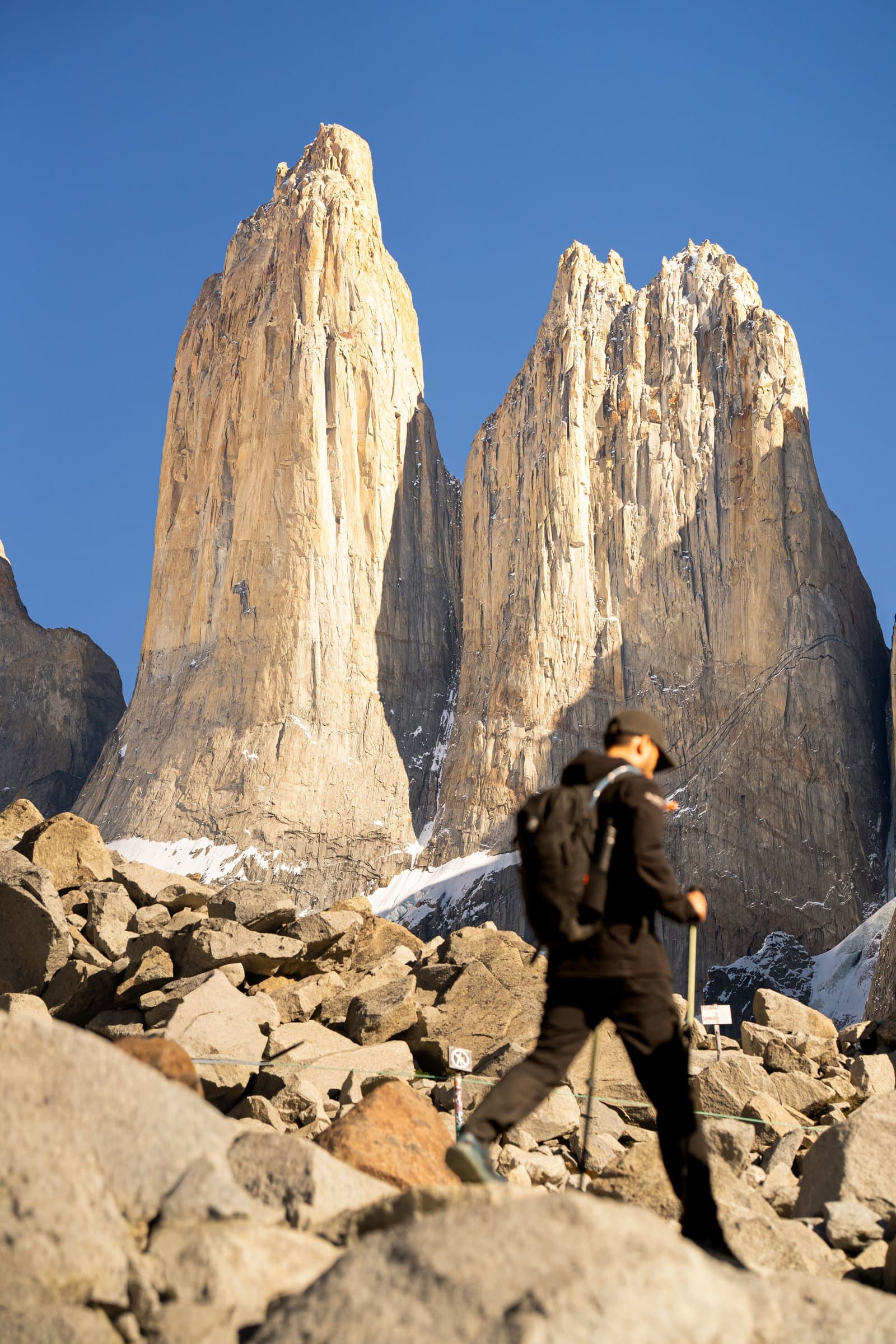 A guide walking toward the granite towers of Torres del Paine